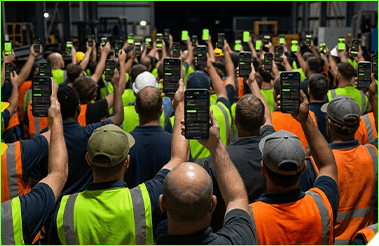A crew in high-vis holding phones up together